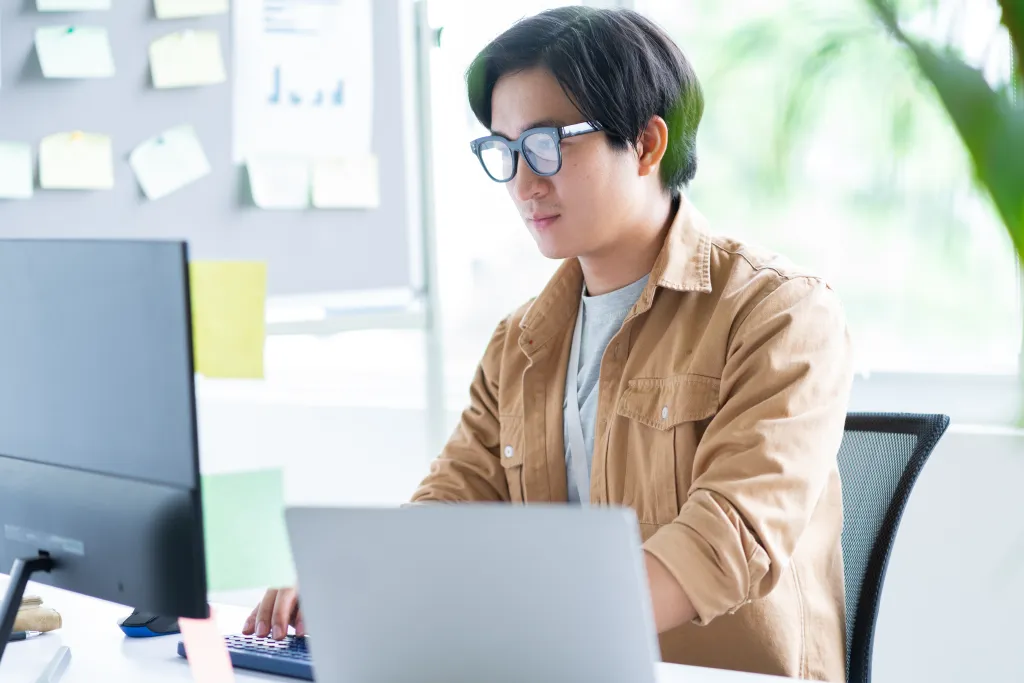 asian-business-man-working-with-laptop-in-office.webp