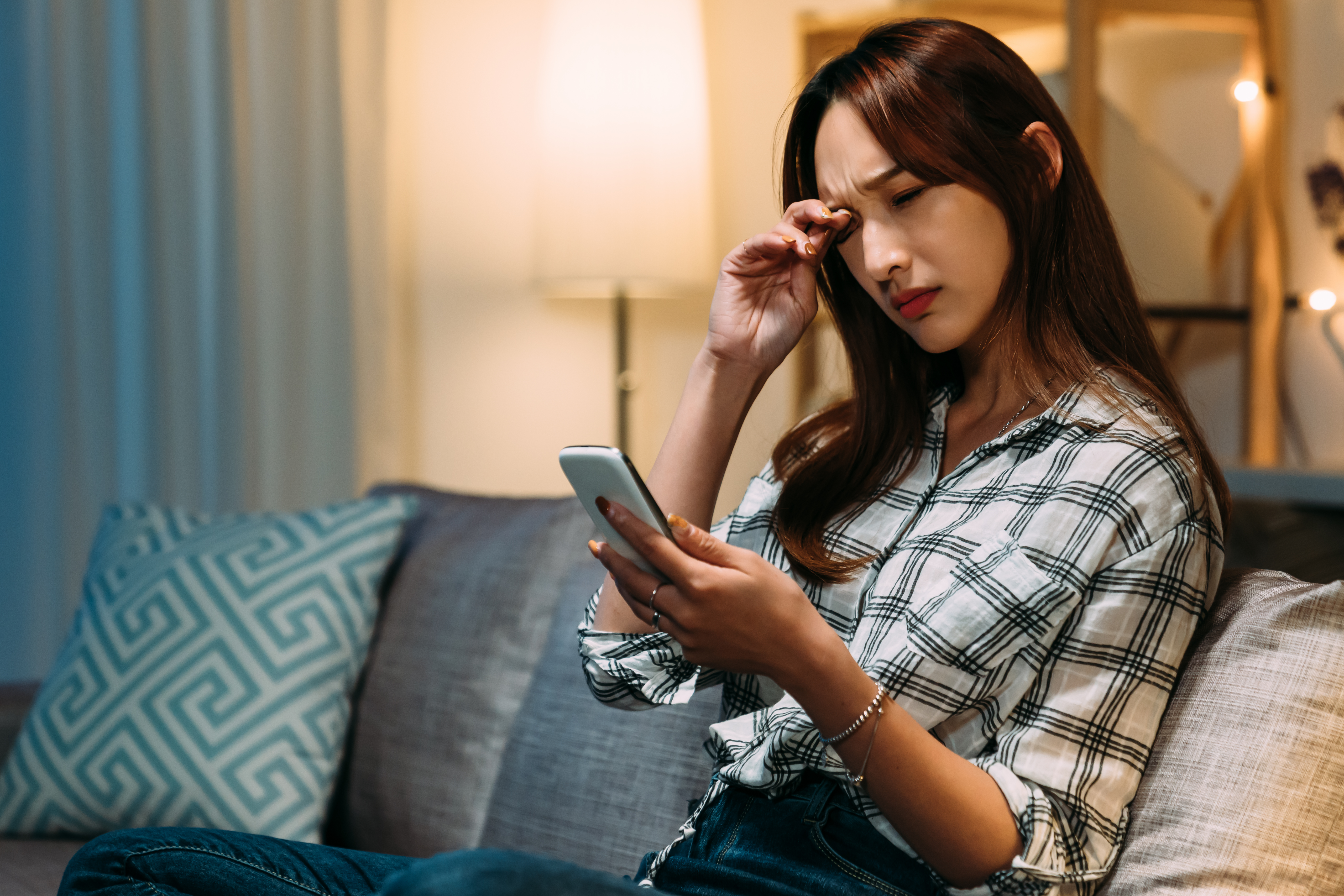 portrait-asian-girl-suffering-from-blurred-vision-is-rubbing-her-tired-eyes-while-holding-using-her-smartphone-living-room-home.jpg